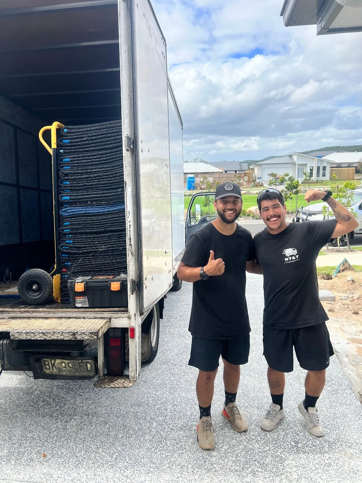 Two MT&T removalists next to the loaded truck